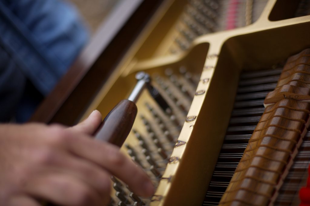 Piano tuner doing his thing